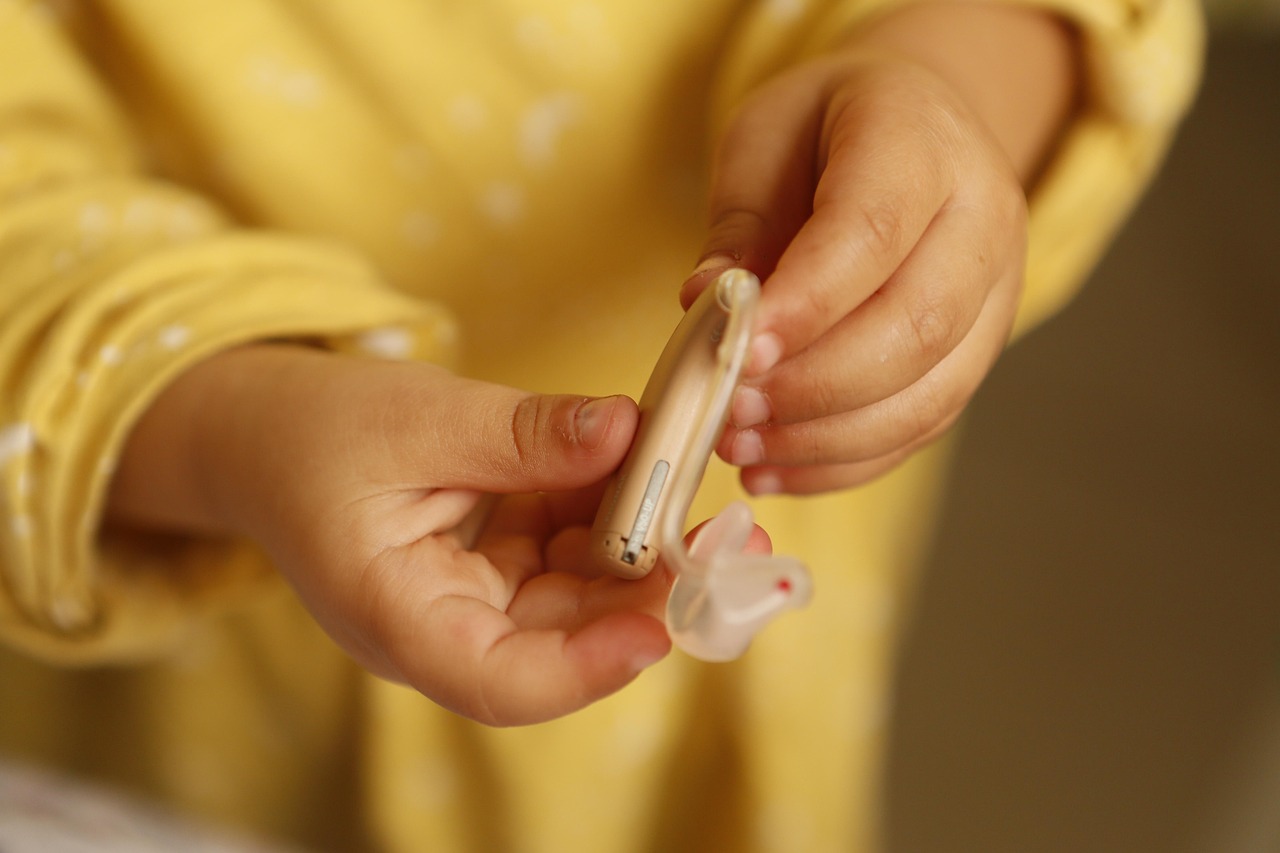 Close-up of a modern behind-the-ear hearing aid, representative of devices compared in this performance analysis